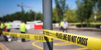 Police tape cordons off a street scene