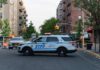 NYPD police SUV blocking a city street at a taped-off scene