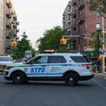 Off-Duty Detective Stabbed – Manhunt Explodes NYPD police SUV blocking a city street at a taped-off scene