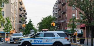 NYPD police SUV blocking a city street at a taped-off scene