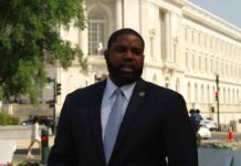 Baseless Blast Backfires – Apology Follows Man in a suit speaking outside a neoclassical government building