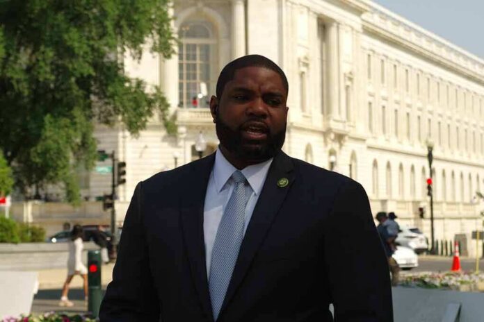 Man in a suit speaking outside a neoclassical government building
