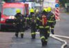 Wind-Whipped Blaze Stops At Holy Door Firefighters walking toward a scene with hoses and a red emergency van