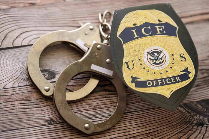 ICE officer badge and handcuffs on wooden surface