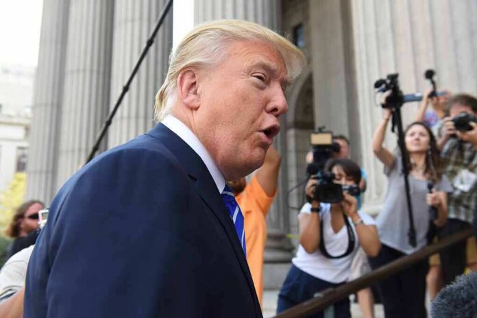 man in suit speaking to media outside a courthouse