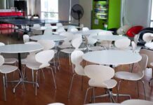 A Cafeteria Emergency Just Became a Terrorism Case Empty cafeteria with white round tables and chairs