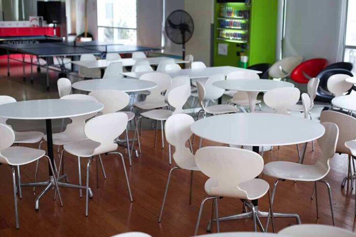 Empty cafeteria with white round tables and chairs