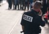 Embassy Alert: Avoid Paris Hot Zones Police officer in uniform communicating with a crowd in an urban setting